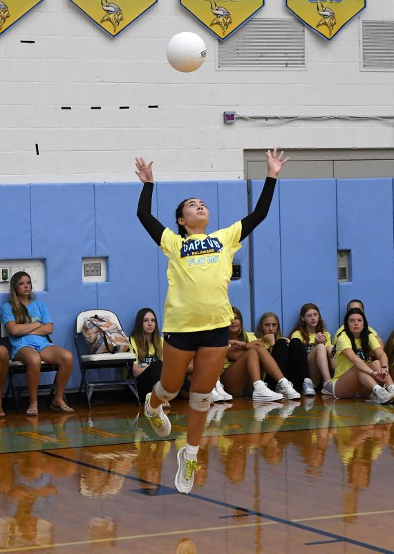 Junior Maggie Minto slams a jump serve in the scrimmage with Newark Charter.