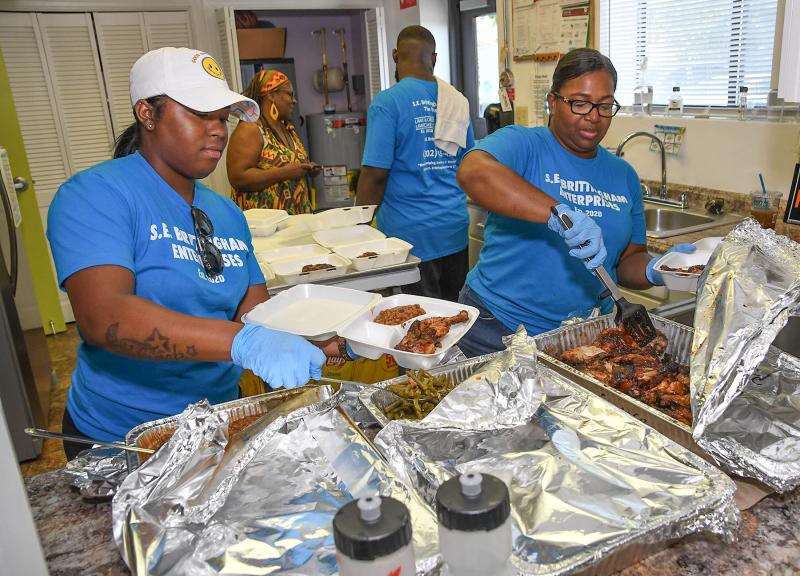 Making the tasty free lunch are I'Myia Custis, coordinator, S.E. Brittingham Enterprises; Marilyn Waples, children's support at West Rehoboth Children & Youth Program; Shayne Brittingham, CEO and founder at S.E. Brittingham Enterprises; Tamela Harmon-Brittingham, executive manager, S.E. Brittingham Enterprises.