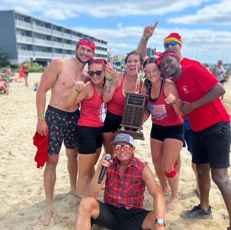 The Paradise Grill team celebrates its trophy with emcee Steve Capik. Shown in back are (l-r) Ryan Cressman, Alisa Clayville, Tanisha Washburn, Liza Ernst, Shawn Armstrong and Kelvin Reynoso. In front is Steve Capik. SUBMITTED PHOTO