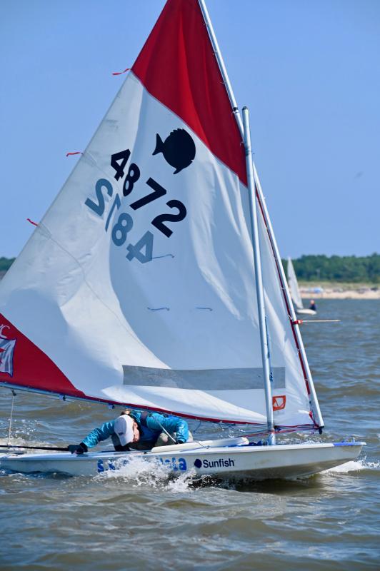 Kimmy Jackman of Bantam Lake Yacht Club (Morris, Conn.) prepares to come about as she ducks under the mast. She finished 11th overall.