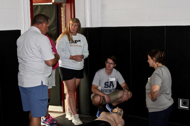 Ed Strapp, co-owner of Sports Medicine Emergency Management, reviews the most recent drill with trainers. Shown are (l-r) Strapp, Cape Henlopen athletic trainer Ashley Schuster, Sussex Academy athletic trainer Brian Hubeler and Cape Henlopen athletic trainer Hollyann Wettstein.