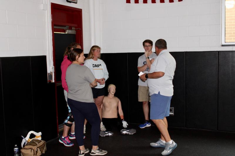 Sports Medicine Emergency Management co-owner Ed Strapp tells the trainers playing victims what they need to do to simulate a real-life situation. Shown are (l-r) Cape Henlopen athletic trainer Hollyann Wettstein, Cape Henlopen athletic trainer Ashley Schuster, Sussex Academy athletic trainer Brian Hubeler and Strapp.