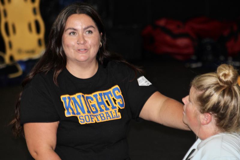 Sussex Central athletic trainer Becca Smith checks on Cape Henlopen athletic trainer Ashley Schuster who is simulating someone with the sickle-cell trait struggling during a training session in hot weather.