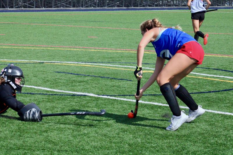 Sophomore goalie Abby Tatman does her best to try and stop a shot from fellow sophomore defender Ava Yenovkian.