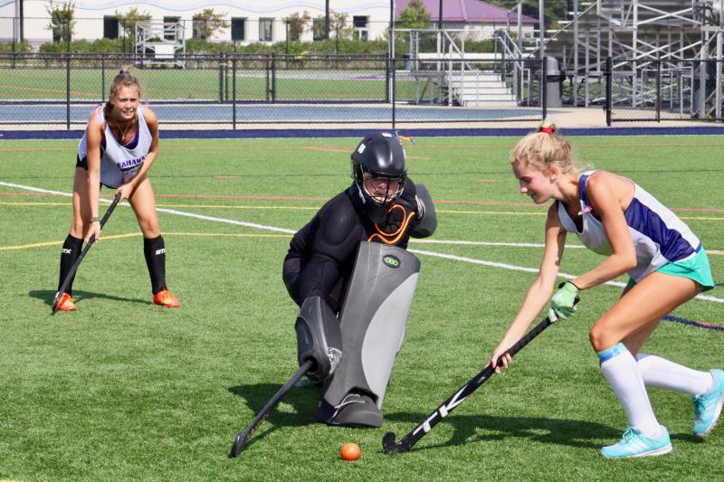 Junior forward Emma Campbell sets up on the backside of the goal as sophomore goalie Abby Tatman stops junior Julie Daniello’s drive towards goal.