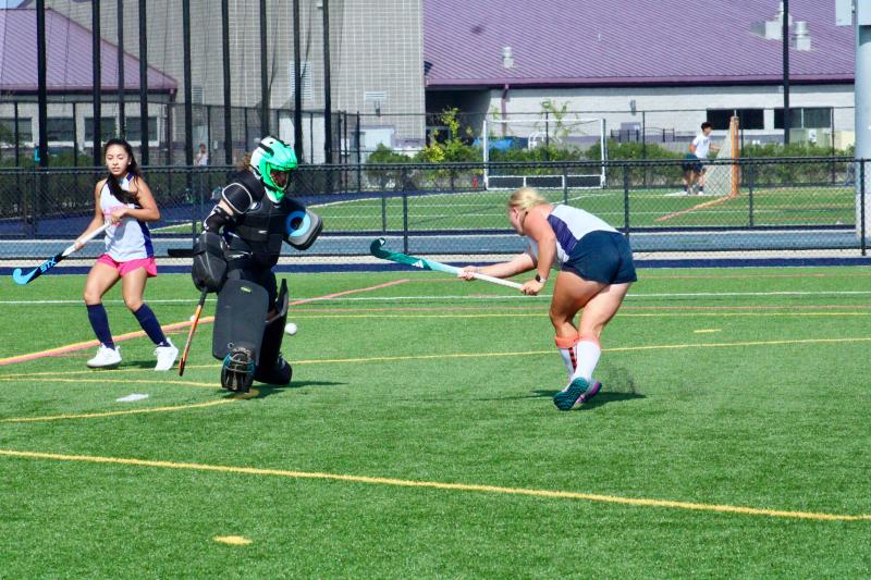 Senior midfielder Angie Chilel-Ramirez waits for a rebound that won’t come as sophomore goalie Kacie Rawlings saves a blast from senior forward Callie Short.