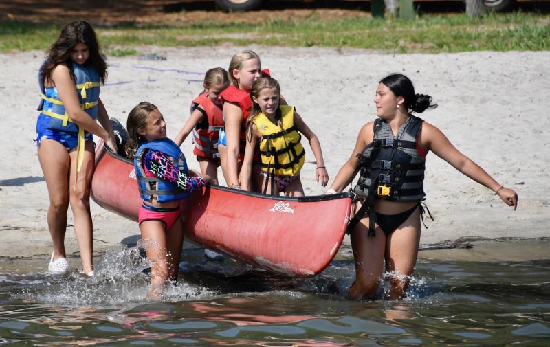 Although it looks like this group of girls is going canoeing, they are actually one of the teams in the sinking-boat activity.