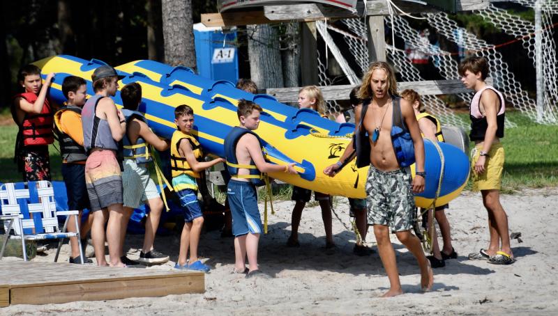It’s all hands on deck as campers unload and prepare to carry the camp’s inflatable raft out on the water.