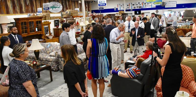 A large crowd fills the Habitat ReStore near Lewes Aug. 4 for the presentation of a federal housing repair grant.