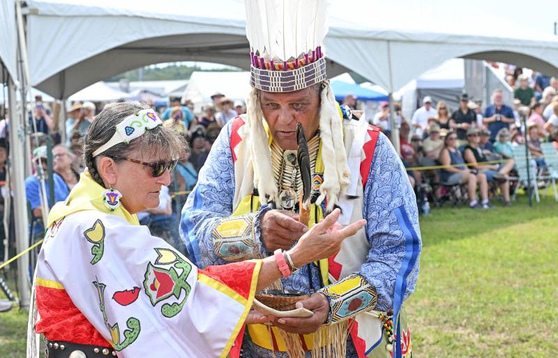 Prior to the blessing of the dance circle, the participants are cleansed. Nanticoke storyteller Ragghi Rain, left, is cleansed by Herman Jackson.