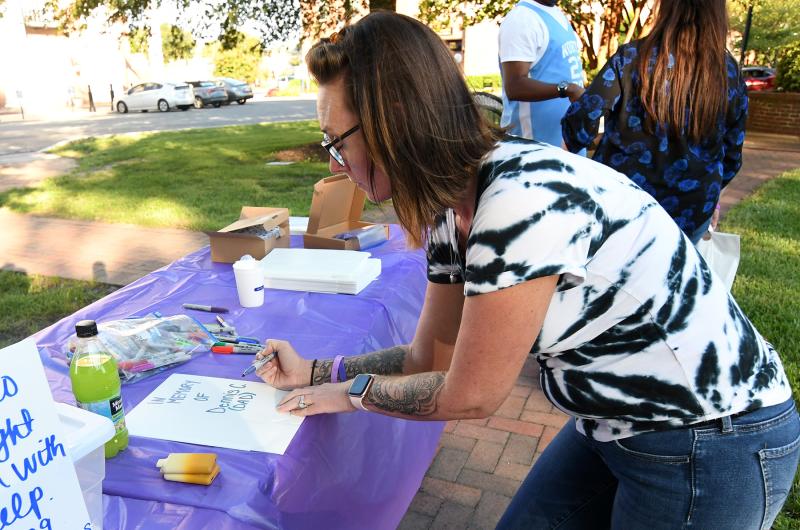 Kandice Seymore makes a paper bag luminary to honor her father Dennis. Seymore works at the Banyan Treatment Center in Milford.