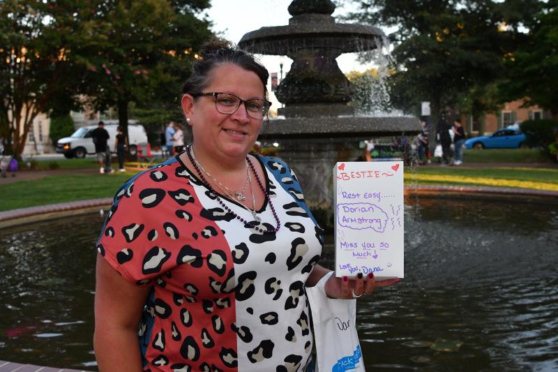 Dana Timmons of Milford holds a luminary to honor her best friend Dorian Armstrong, who died of an overdose May 9, 2023.