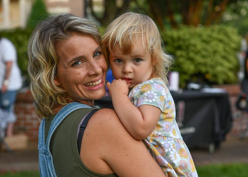 Ashley Duval hugs her daughter Gabriella, 2, during the event. “I’m three years in recovery,” said Duval, who works for Banyan Treatment Center.