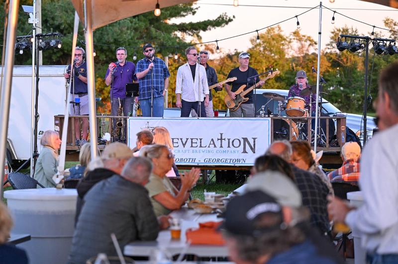 Attendees enjoy a libation from Revelation Beer Garden while munching down on a burger from the Smash Mouth food truck.