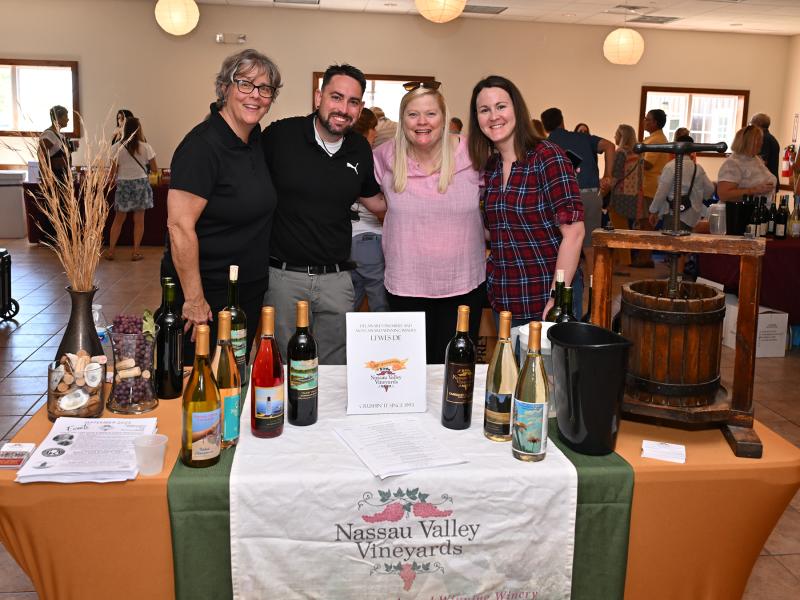 Showing their happy smiles at the Nassau Valley Vineyards table are (l-r) Val Gazda, Wes Patton, Peggy Raley-Ward and Amy Patton.
