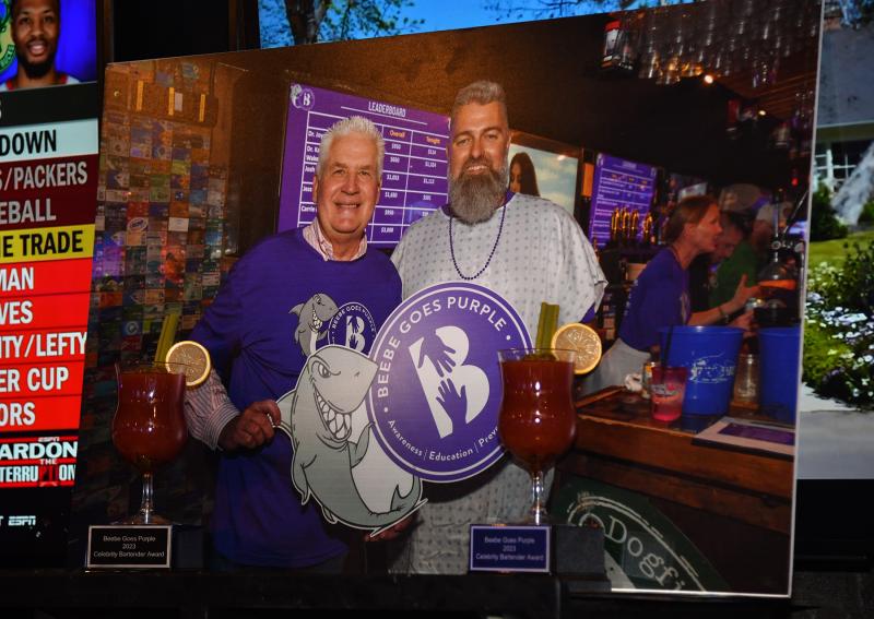 A photo displayed above the bar honored longtime Beebe board member and supporter Terry Megee, who passed away suddenly July 27. Megee is pictured with Christian Hudson, also a long-serving friend of Beebe.