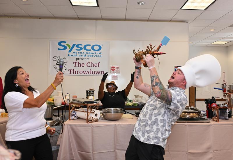 Mystery basket creator and presenter Hari Cameron surprises the chefs with the lobsters they must use in their dish.