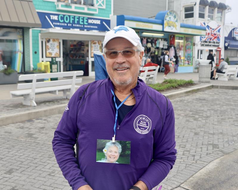 Mike Fusca of Lewes wears a photo of his mother, Mary. He said she lived with Alzheimer’s for 11 years but always kept her smile.