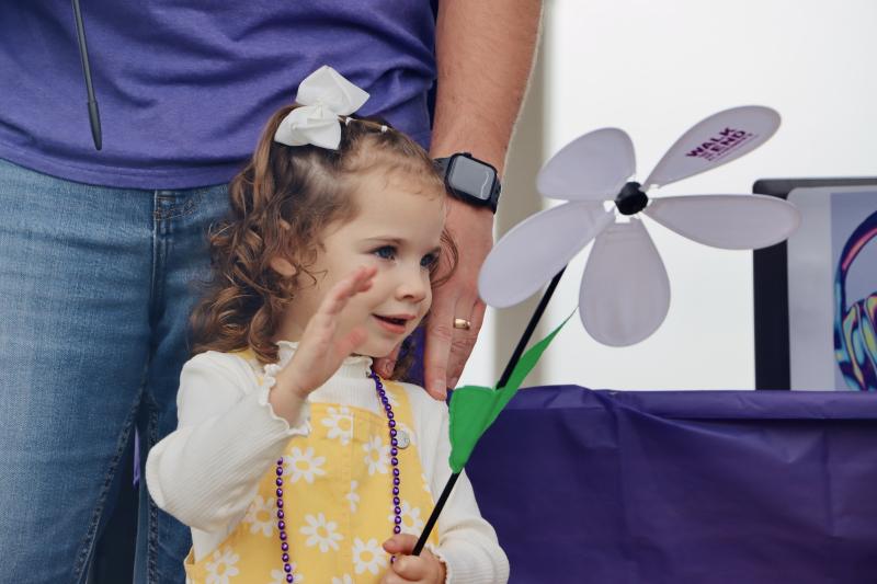 Finley Smith holds the only white flower in the walk, which represents the first person who will someday survive Alzheimer’s.