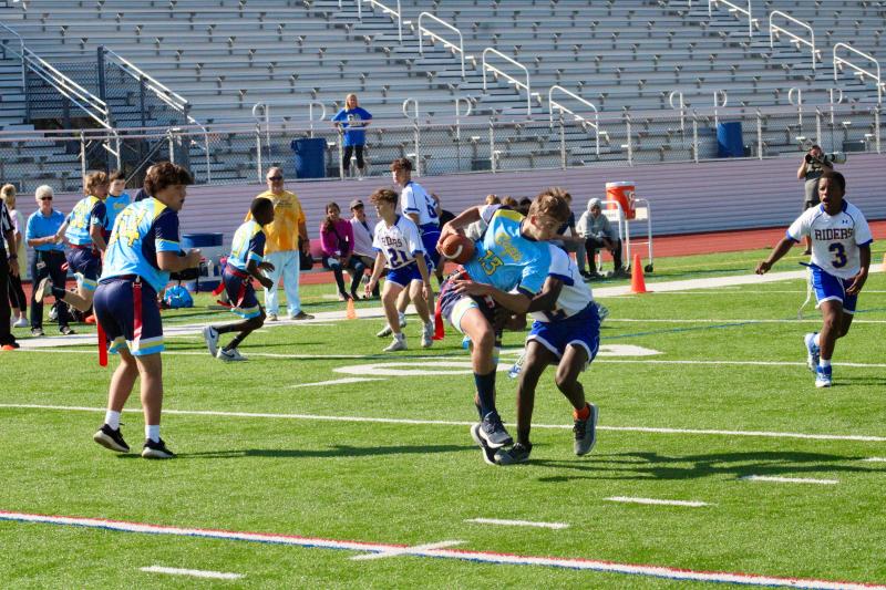 Vikings senior Connor Pencek is tackled in the backfield by Riders freshman Al’Kwaughn Murphy-Simms after receiving a hand-off.