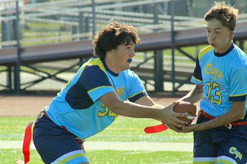 The Cape unified flag football team enjoys running the run-pass option. Shown here is senior quarterback Jackson Wood fakes a handoff to senior Connor Pencek.