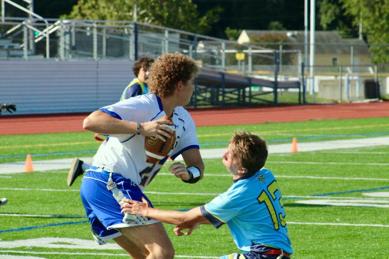 Vikings senior Connor Pencek collects his first sack of the day through tremendous effort and a last-second dive to get the flag of senior Patrick Easton.