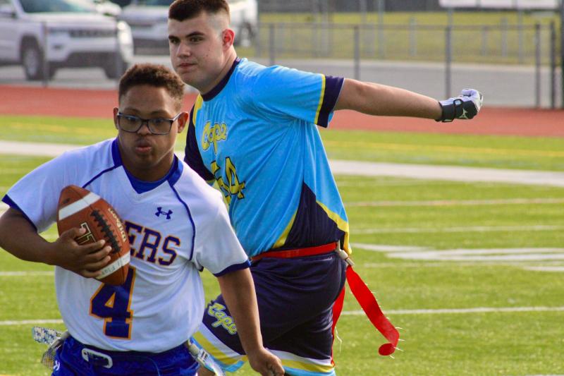 Caesar Rodney junior Rickey Hargis is able to get past Cape junior Randolph Adams, who did good to force Hargis back inside.