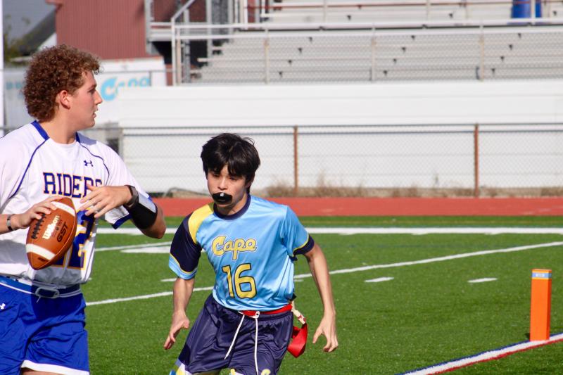 Vikings sophomore Ronald “Ronnie” Leroy pressures Riders senior quarterback Patrick Easton into a rushed pass.