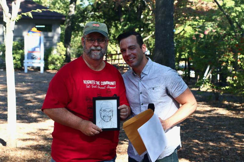 Glen Pruitt, left, was honored by HIV Consortium Executive Director Tyler Berl before the walk. Pruitt has been a fixture in the fight against HIV/AIDS in Delaware. His portrait was among those on this year’s AIDS Walk T-shirt.