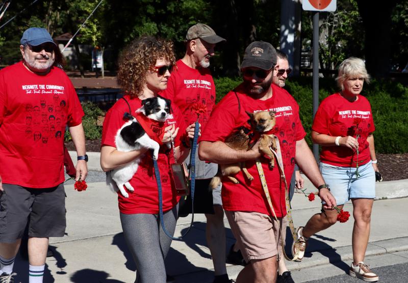 Toni Cruthirds, left, holding Lemieux, and Josiah Urban, holding Artemis, came from New Jersey with three family members to take part in the AIDS Walk.