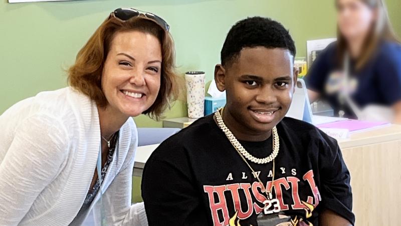 Isaiah Benton, 18, studies and discusses sports with school board President Alison Myers at the Sussex Consortium. SUBMITTED PHOTO
