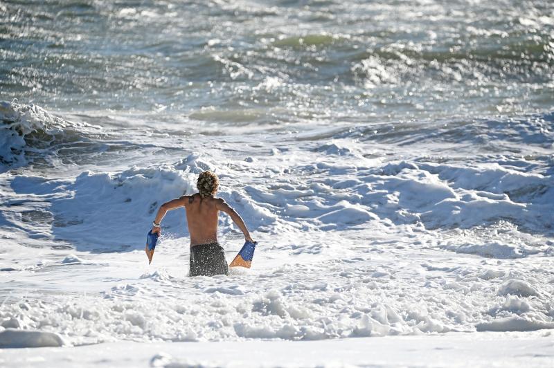 Rehoboth Beach Patrol lifeguard Jonathon Kohr wades out into the surf to check the conditions before taking the stand. Capt. Jeff Giles noted that Kohr is a very experienced guard.