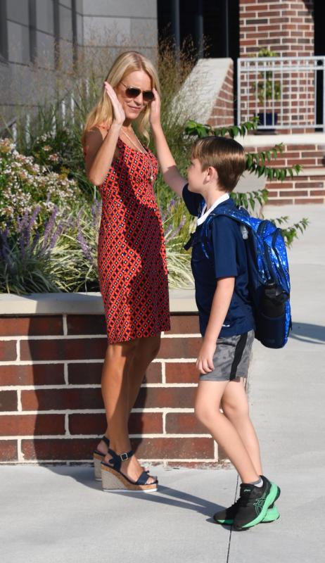 Cape District Assistant Superintendent Jenny Nauman greets Lewes Elementary School students and gets a high-five from Benjamin Muncie. RON MACARTHUR PHOTO