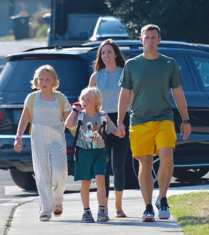 The Husbands family, including parents Panda and Matt, are walking to Lewes Elementary School. Zoe, left, is starting fourth grade and Gavin, center, is in first grade. RON MACARTHUR PHOTO