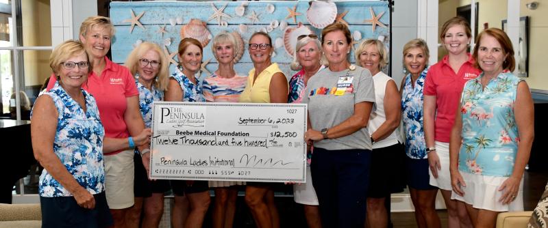 Taking part in the check presentation to Beebe Medical Foundation are tournament committee members and Beebe staff (l-r) Diane Karbonik, event chair; Kay Young, Beebe Medical Foundation; Patti Norden; Brenda Olsen; Diane Collins; Kathy Vaglica; Mary Blazinsky; Kim Blanch, Beebe; Sheila Bardol; Susan Sacchetti; Stephanie Adams, Beebe; and Susan Bies. Missing from the photo is Sue McKenna. RON MACARTHUR PHOTOS