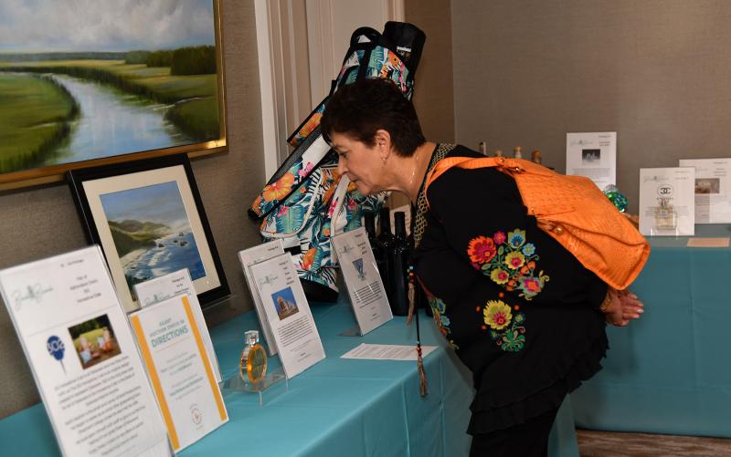 Debra Adelman looks over the silent auction items.