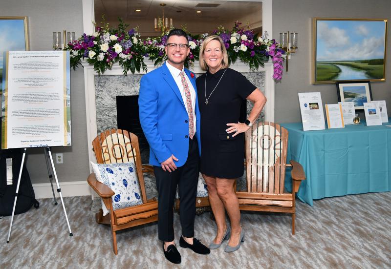 Matt Rice and Katie Wilkinson of sponsor Fulton Bank show off some auction items up for bid at the event.