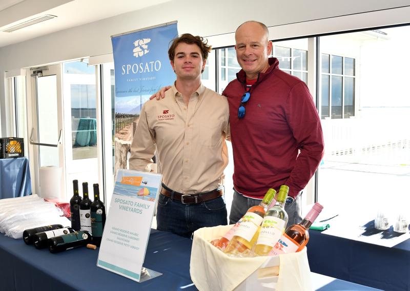 Sposato Wines owner Tony Sposato, right, works the vino table with his son Freddie.