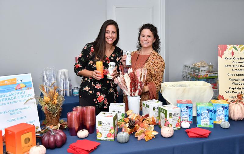 Lindsay Bower, left, and Courtney Davison work the Breakthru Beverage Group table of Ketel One Botanical Spritz.