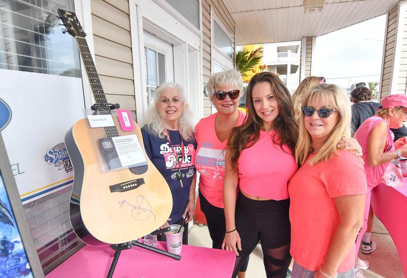 Helping out with the auction event and posing with the autographed Taylor Swift guitar are (l-r) Pat Wright, Bobbie Redefer, Kelly Ranieri and Karen McMahon.