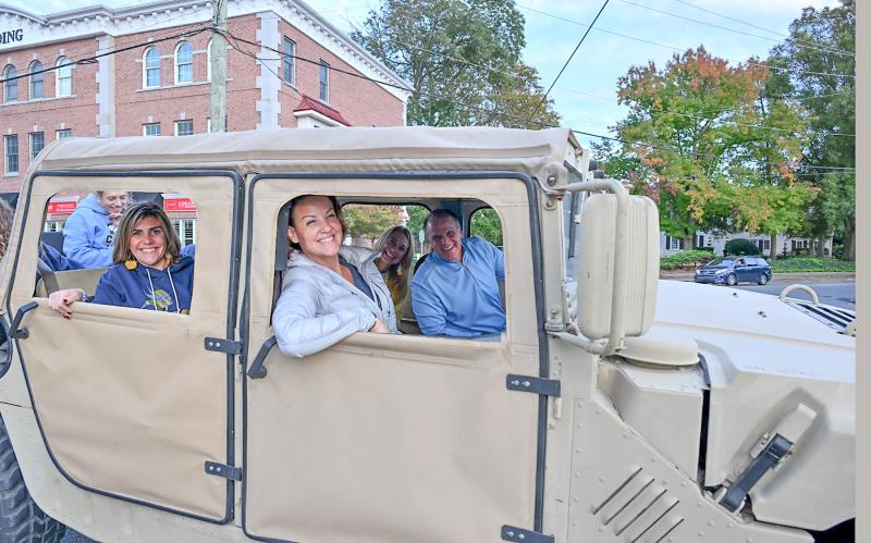 Board members and administration ride in the Army Thing. Shown are (l-r) Jessica Tyndall, Assistant Superintendent Jenny Nauman, board President Allison Myers and Superintendent Bob Fulton.