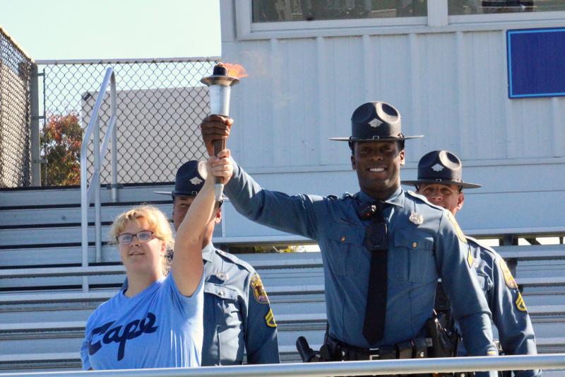 Cape Henlopen High School’s Charlotte Maxwell had the honor of running the torch into the stadium with a Delaware State Police escort, holding it high for all athletes to see.