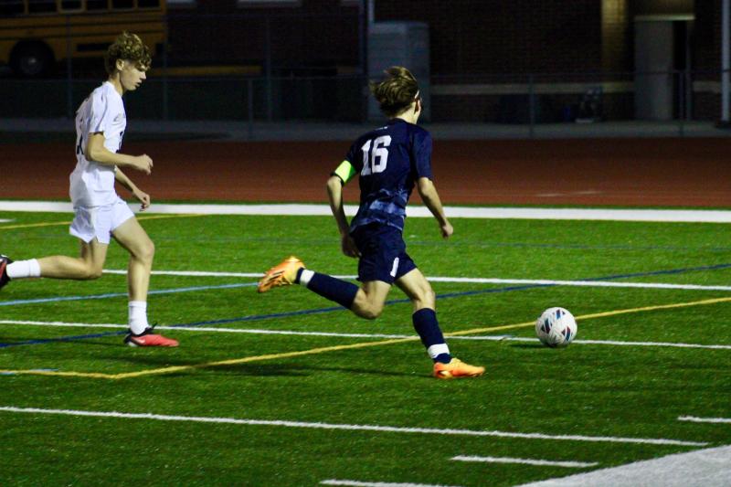 Cape junior Cardin Benjamin races down the right flank and past Sussex Academy sophomore Chase Ballinger.