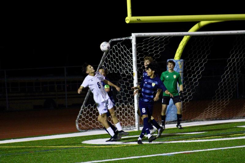 Sussex Academy junior AIden Villar keeps the ball alive in the Vikings' box as the Cape defenders prepare to clear the headed ball.