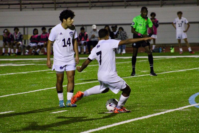 Sussex Academy junior Andres Romero-Nieto boots a free kick as senior Andree Mendoza-Martinez looks on.