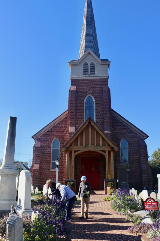 Weeders volunteers tend to the flowers along the main entrance to St. Peter’s. They said people coming to church on Sunday mornings often comment on how beautiful the garden is.