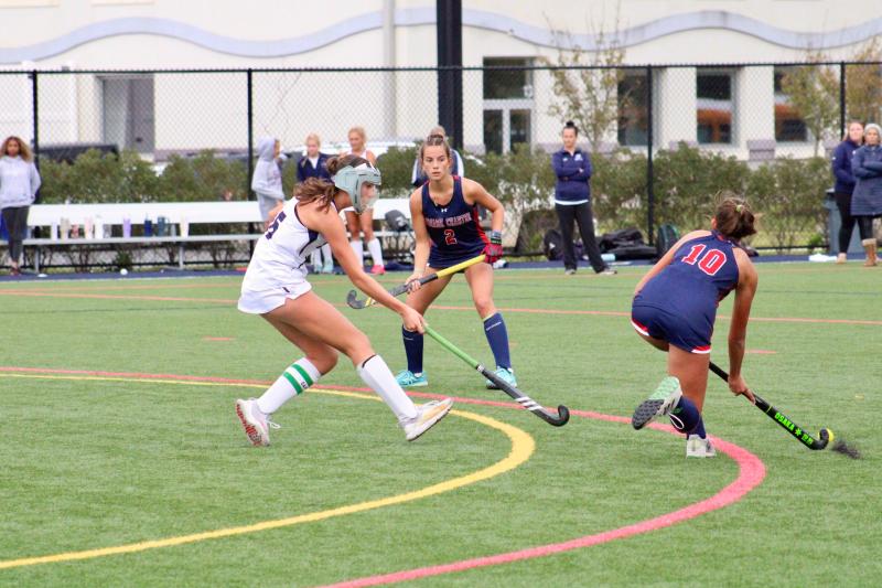 Seahawks junior Shelby Manlove races out to challenge Patriots sophomore Audrey Nelson, who is passing the ball to Kate Ambrose.
