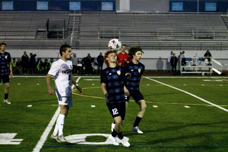 Vikings junior Brandon Loucks controls both the ball and his mouthpiece on this first-half throw-in.