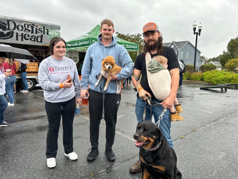 Waiting in line for a beer are (l-r) Kristen Bell, Hoyt Merchant, Tito the dog, Brandon Feaster, Grayson Feaster and Fancy the Rottweiler.