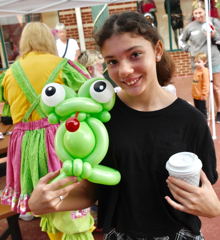 Elise Rodgers stood in line a long time to get this frog balloon creature at the children’s activities at First Street Station. RON MACARTHUR PHOTO